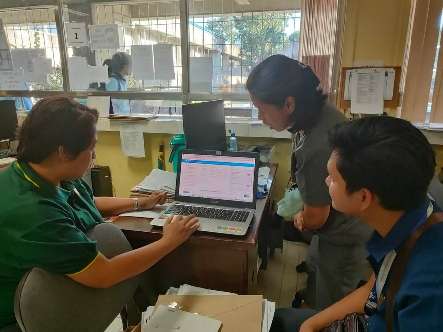 People reviewing a registrar workflow together at a laptop